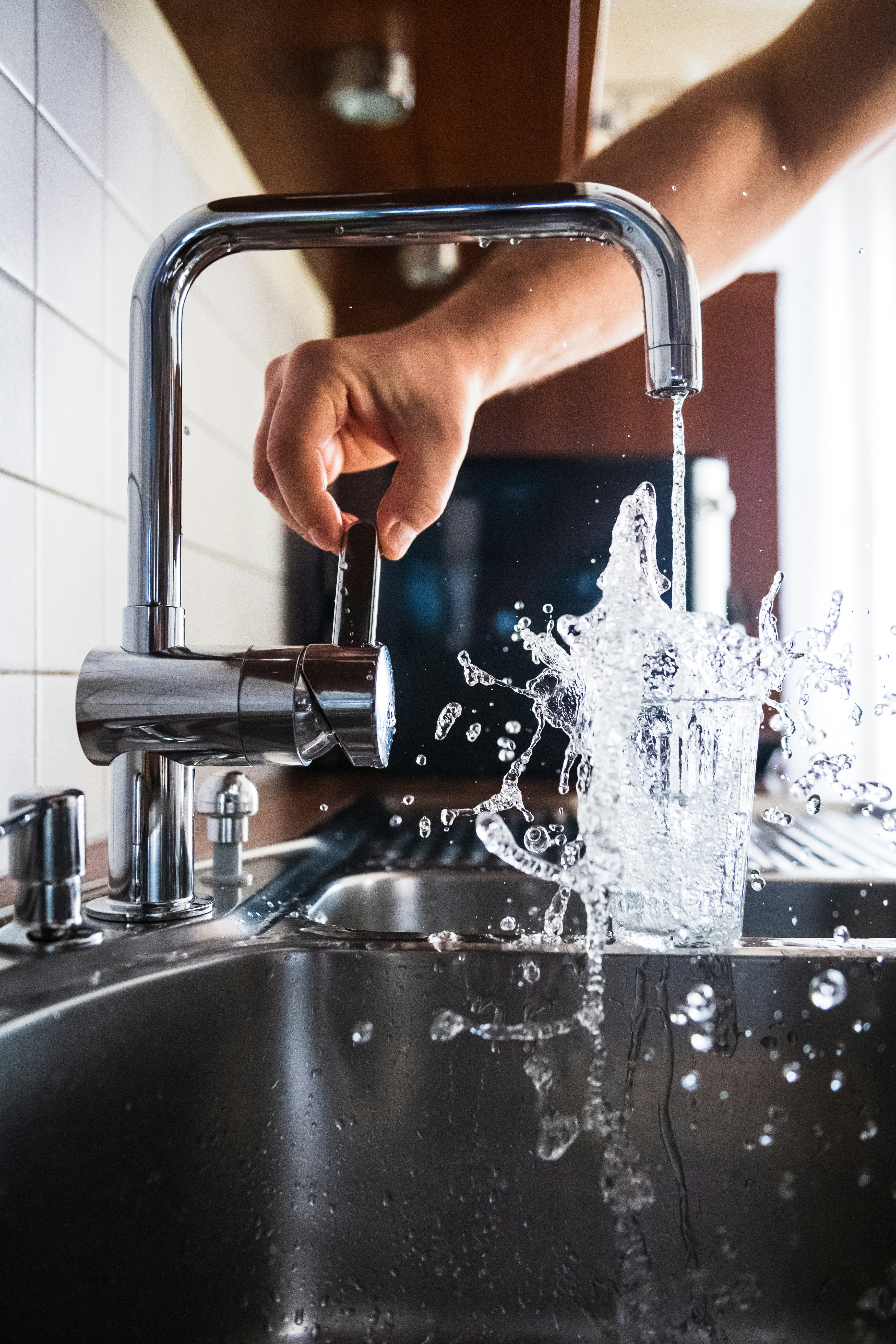 Clean water pouring from a faucet — plumbing and hard water illustration